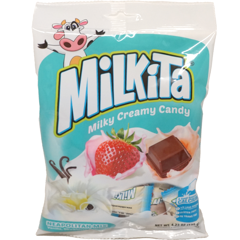 Front view of package. The package features vibrant and appealing imagery with a playful cow character, evoking a sense of fun and freshness. The front showcases luscious visuals of vanilla flowers, ripe strawberries, and creamy chocolate squares, surrounded by a splash of milk, emphasizing the rich and creamy nature of the candy. The bottom part of the package hints at the assortment of flavors inside, adding to the excitement of discovering each piece.