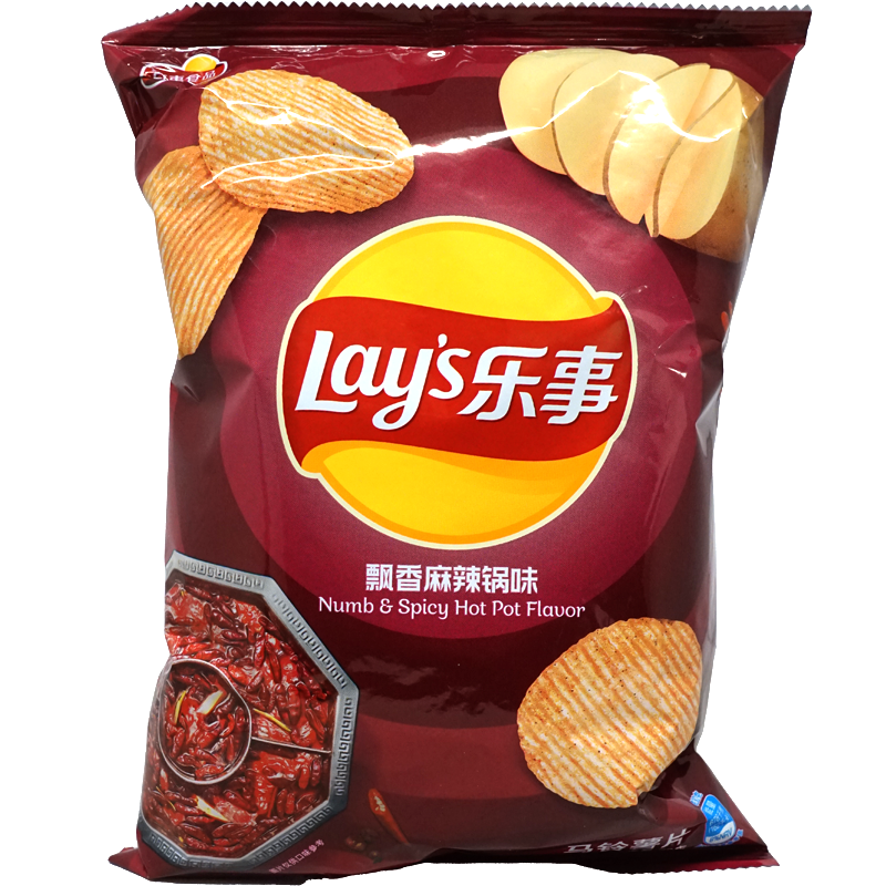 Front view of package. The vibrant packaging features a bold red background, showcasing an enticing image of the spicy hot pot with a medley of aromatic spices. The chips are prominently displayed, highlighting their ridged texture and enticing flavor. The design exudes a sense of adventure and excitement, inviting consumers to experience the intense and unique taste.