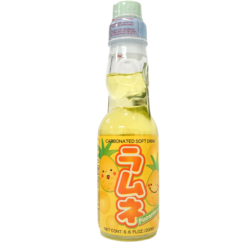 Front of glass bottle of pineapple-flavored carbonated soft drink with cartoon fruit designs.